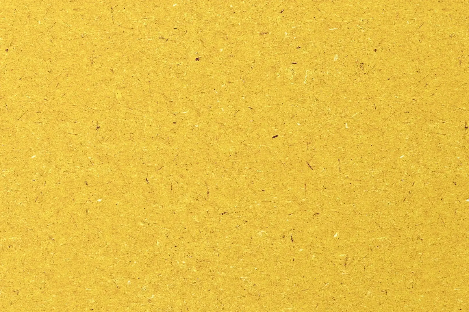 Close-up of an orange recycled paper with lots of different shades of fibers