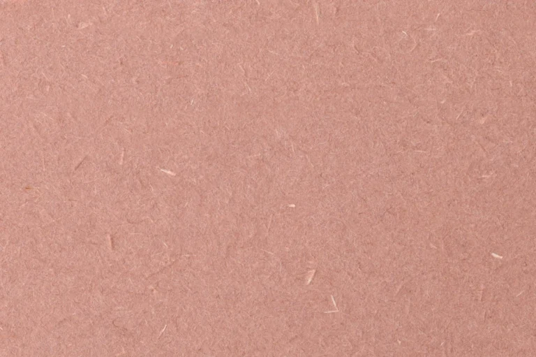Close-up of recycled paper with speckles of white fibers