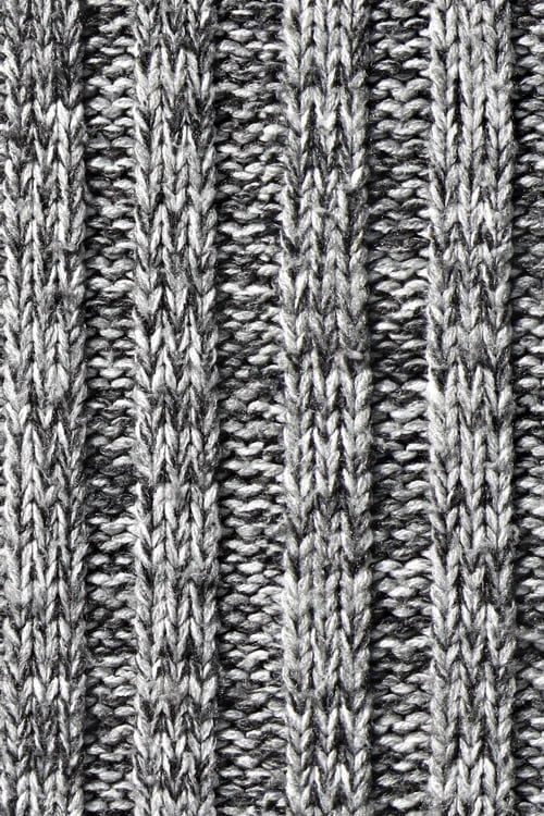 Close-up of an embossed knit sweater with black and white yarns