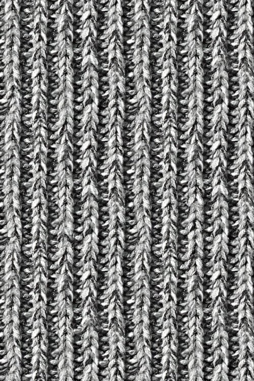 Close-up of an embossed knit sweater with black and white yarns