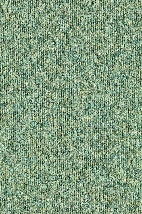 Close-up of a green fine knitted fuzzy pullover
