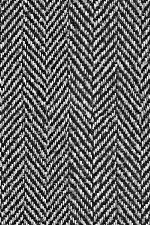 Close-up of a black and white woven fabric with a fishbone pattern