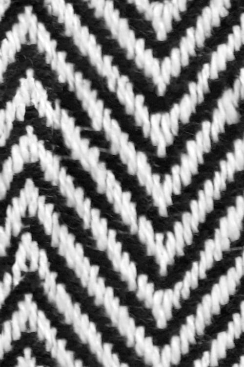 Close-up of a black and white fishbone zigzag patterned textile