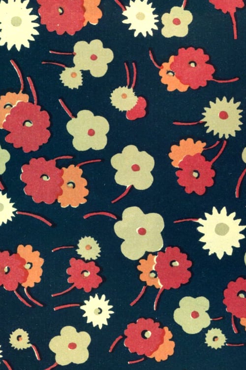 Close-up of a floral pattern of white, pink and red flowers on dark blue background