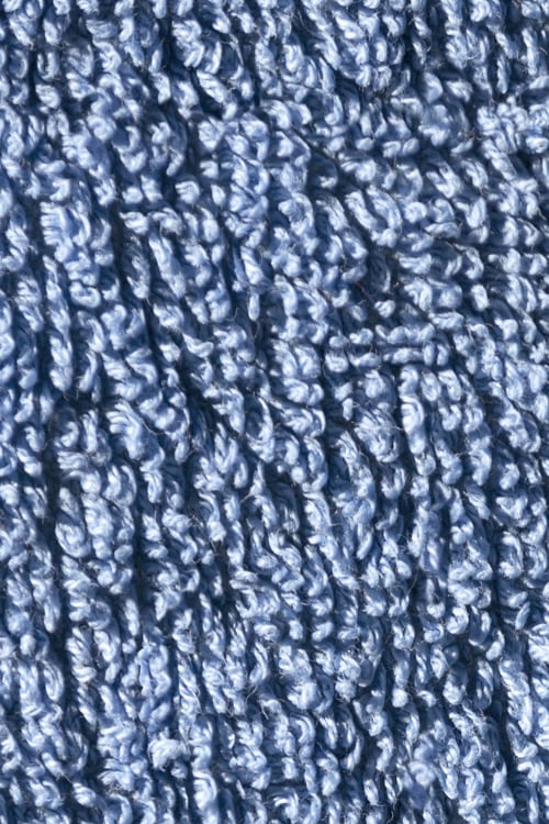 Close-up of a shaggy blue bath mat rug