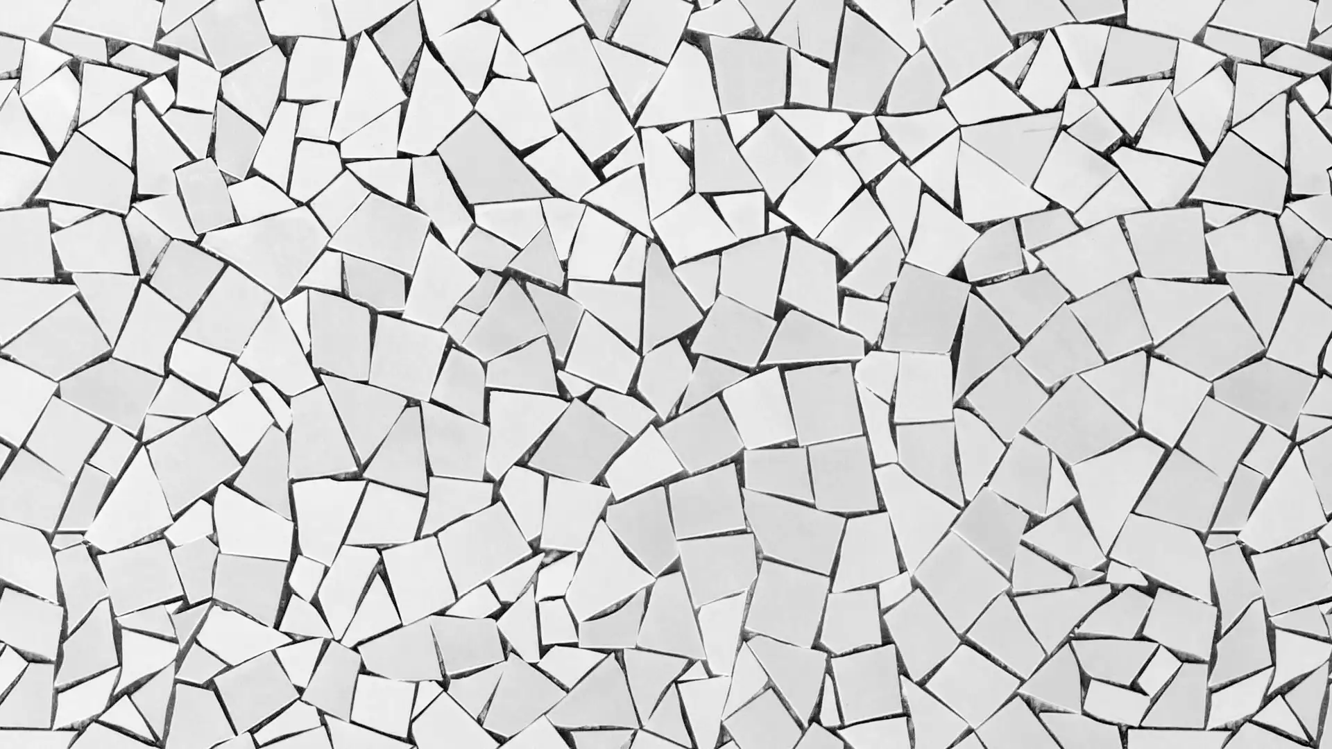 Close-up of a shattered white mosaic wall