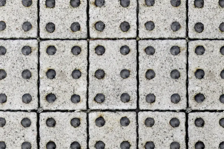 Close-up of concrete pavers with round anti slip steel studs