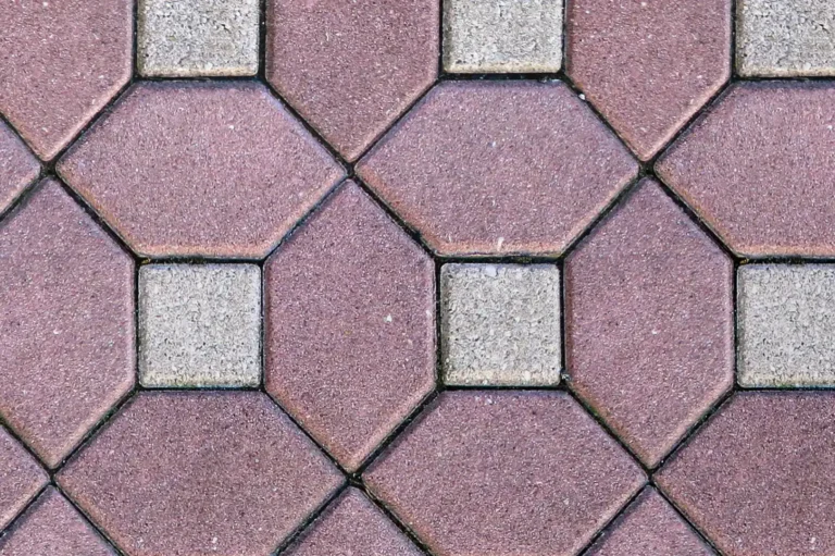 Close-up of a red and white geometric concrete pavement