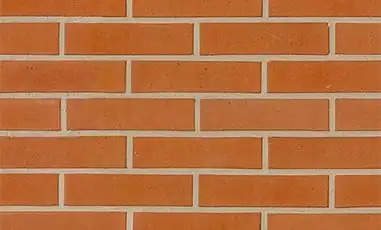 Clean red brick wall with fine white grouting.