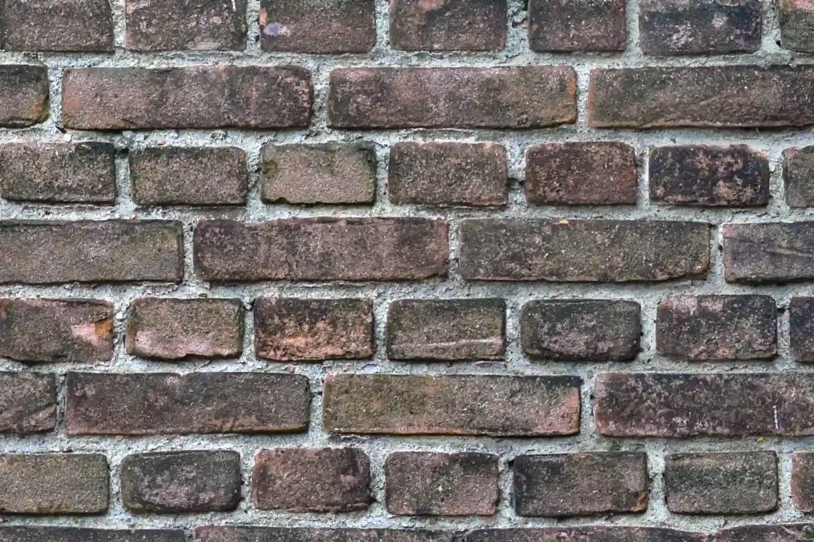 Close-up of an aged dark brick wall