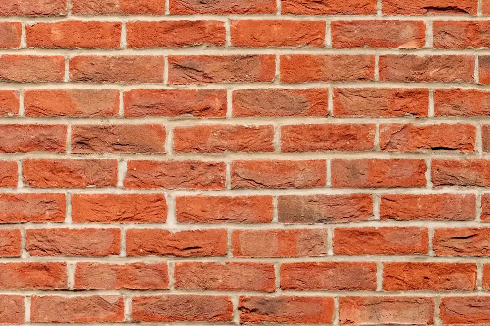 Close-up of a decorative red brick wall with crumbling surface