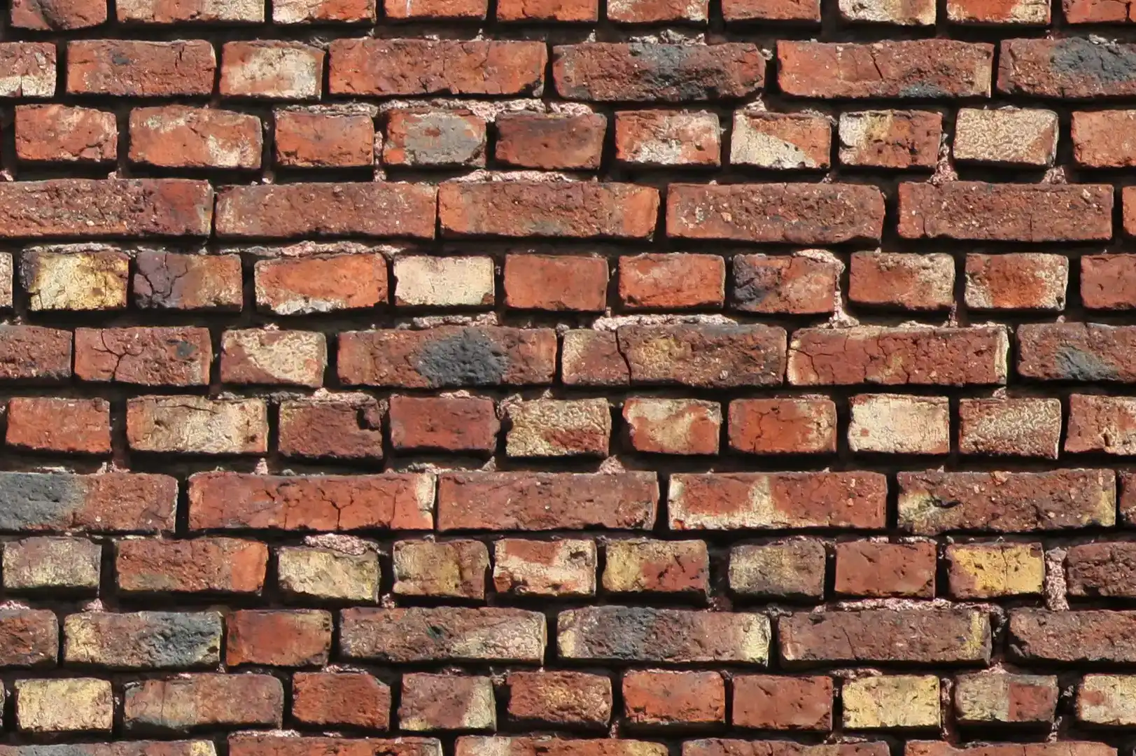 Close-up of an old brick wall with missing mortar