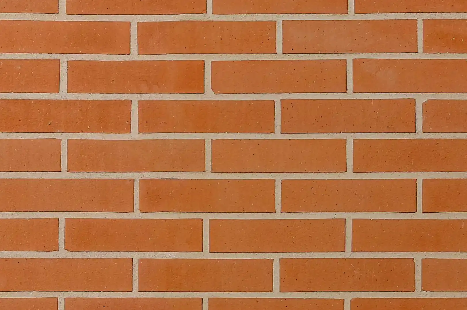 Close-up of a smooth decorative orange brick wall