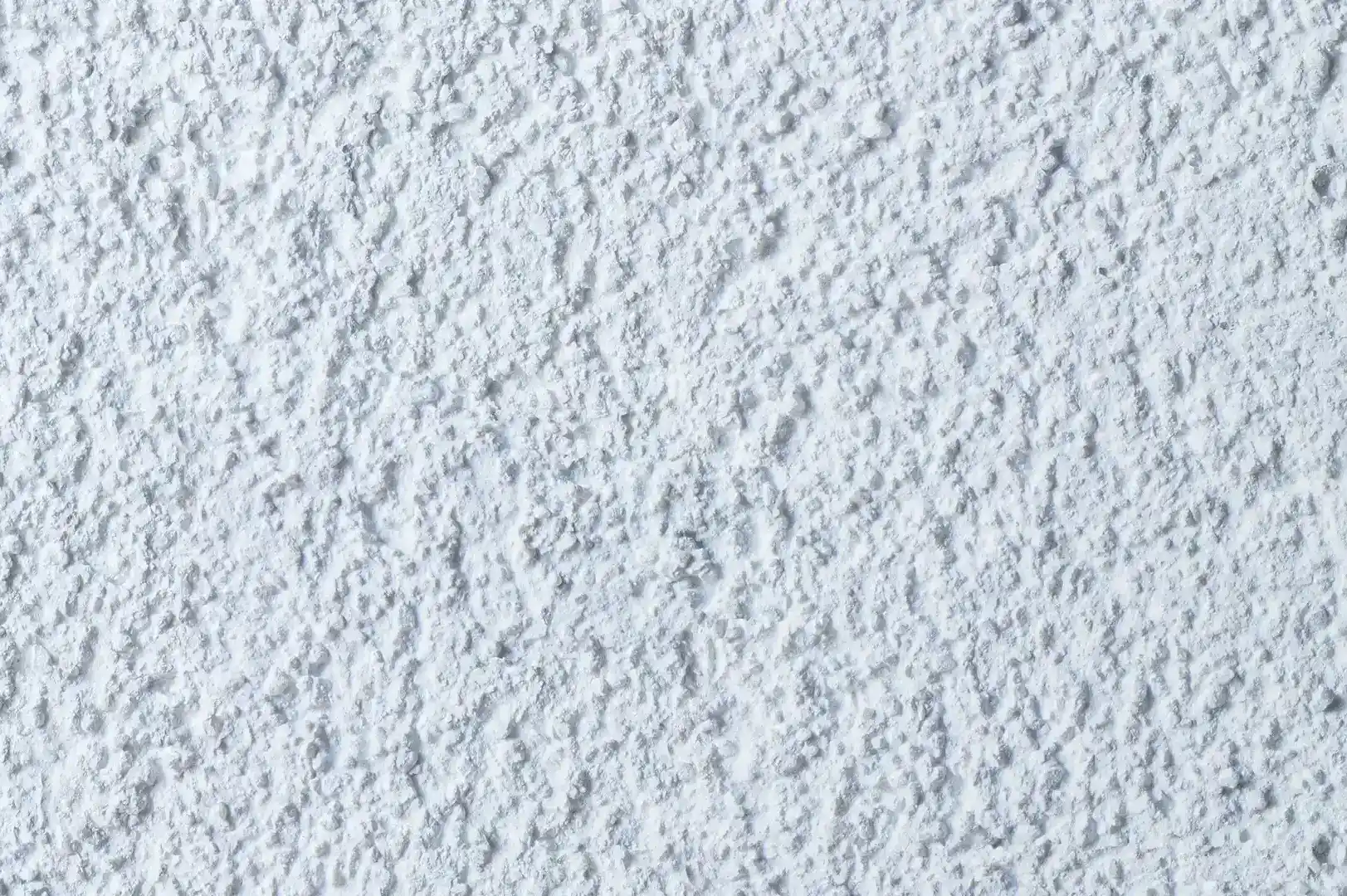 Close-up of a white rough plaster wall