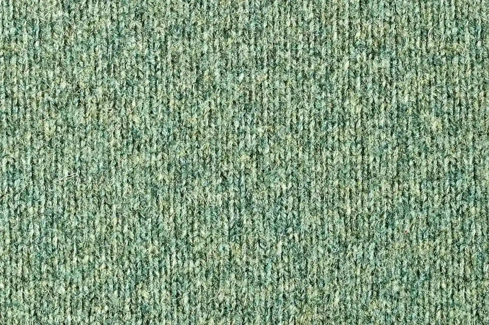 Close-up of a green fine knitted fuzzy wool pullover