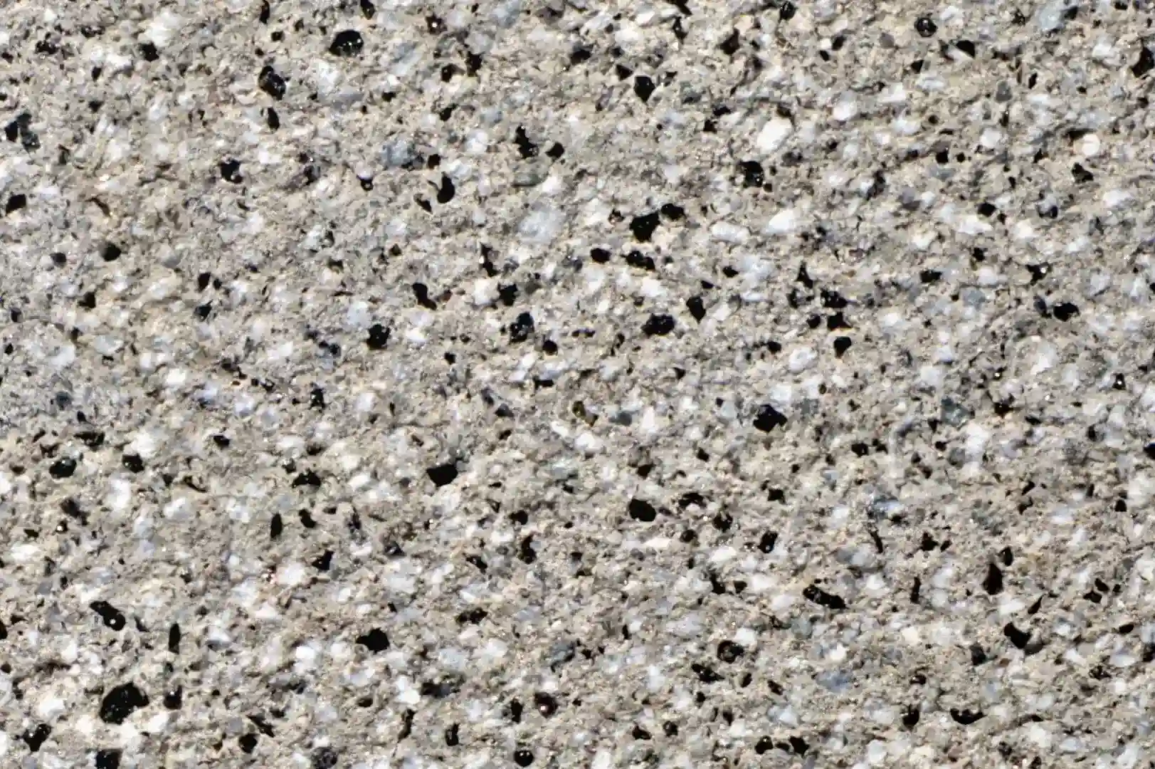 Close-up of a marble plaster with black, white and grey granulates