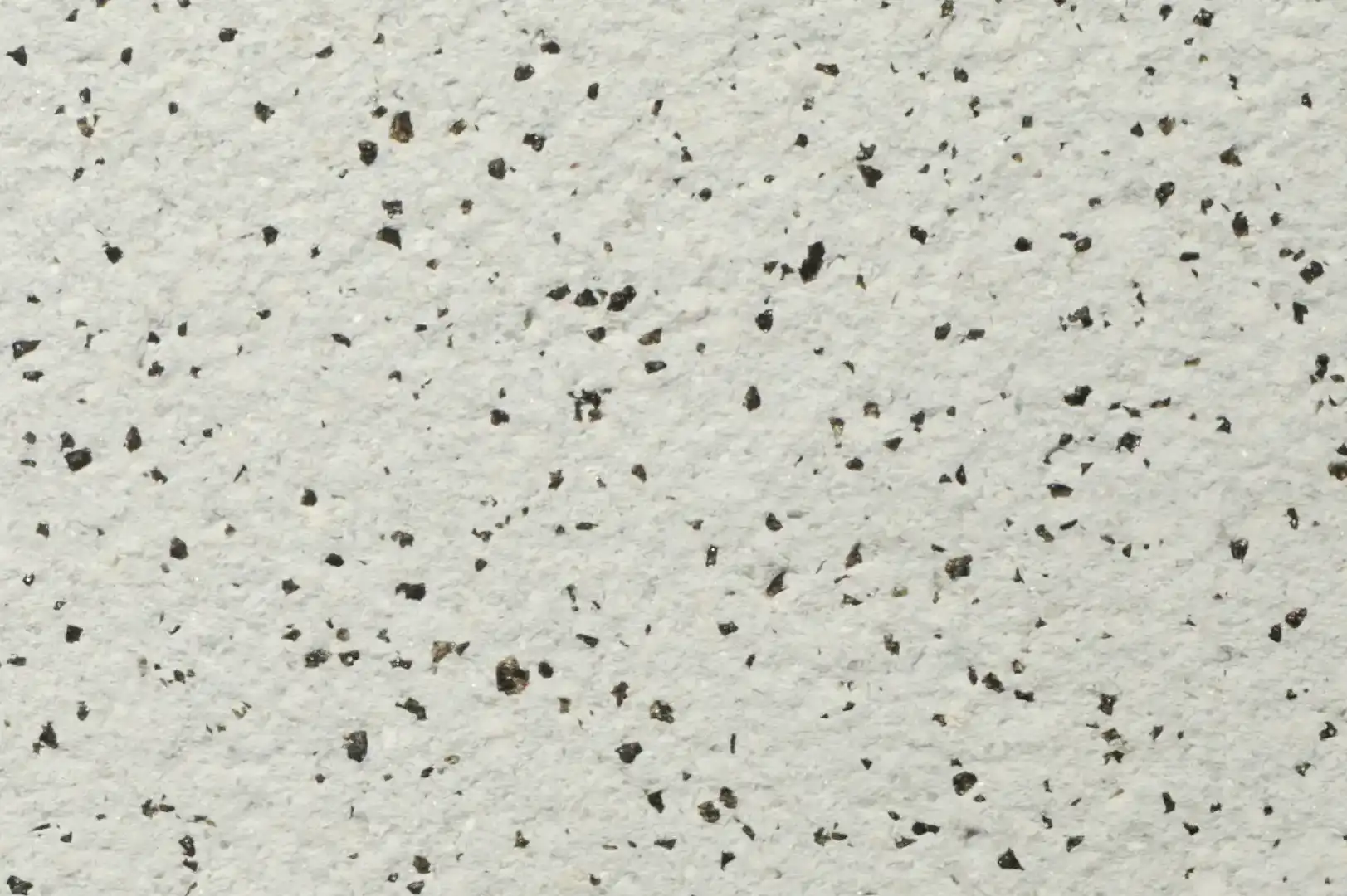 Close-up of a decorative white plaster with black specs