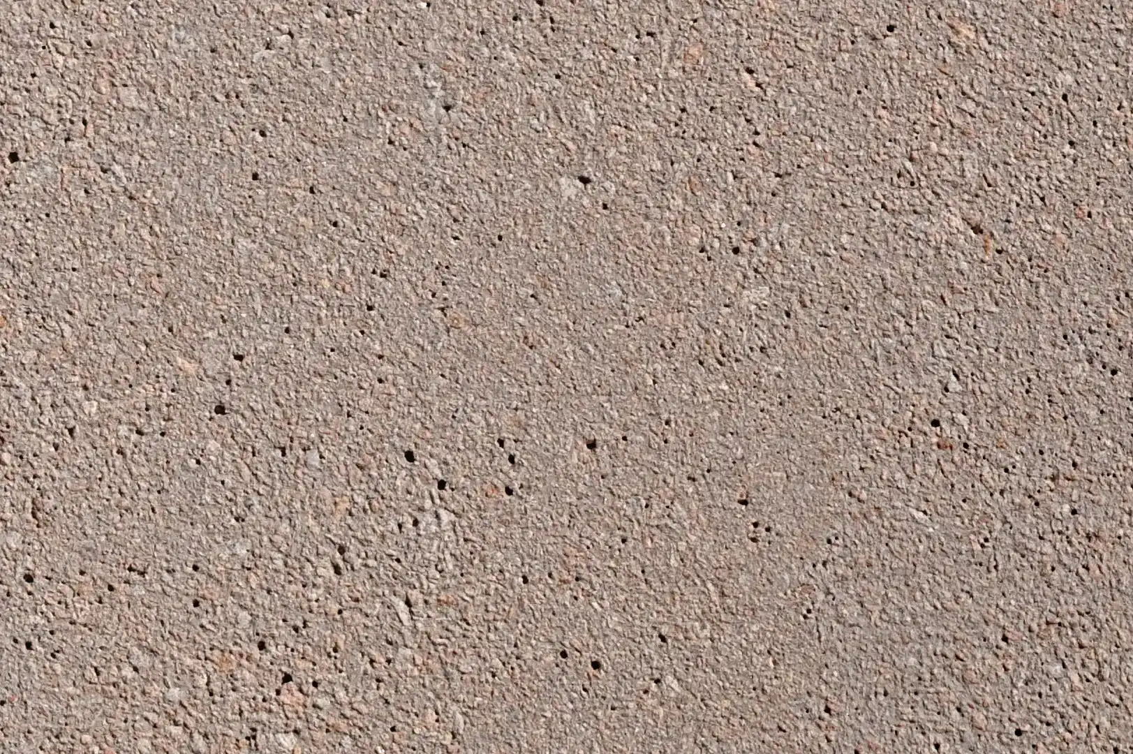 Close-up of a smooth, warm concrete porous surface