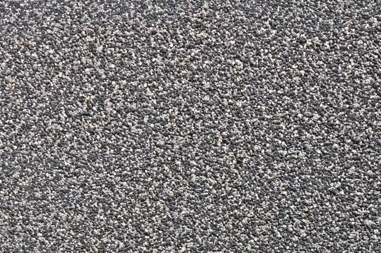 Close-up of a wall plaster with fine black and white pebbles