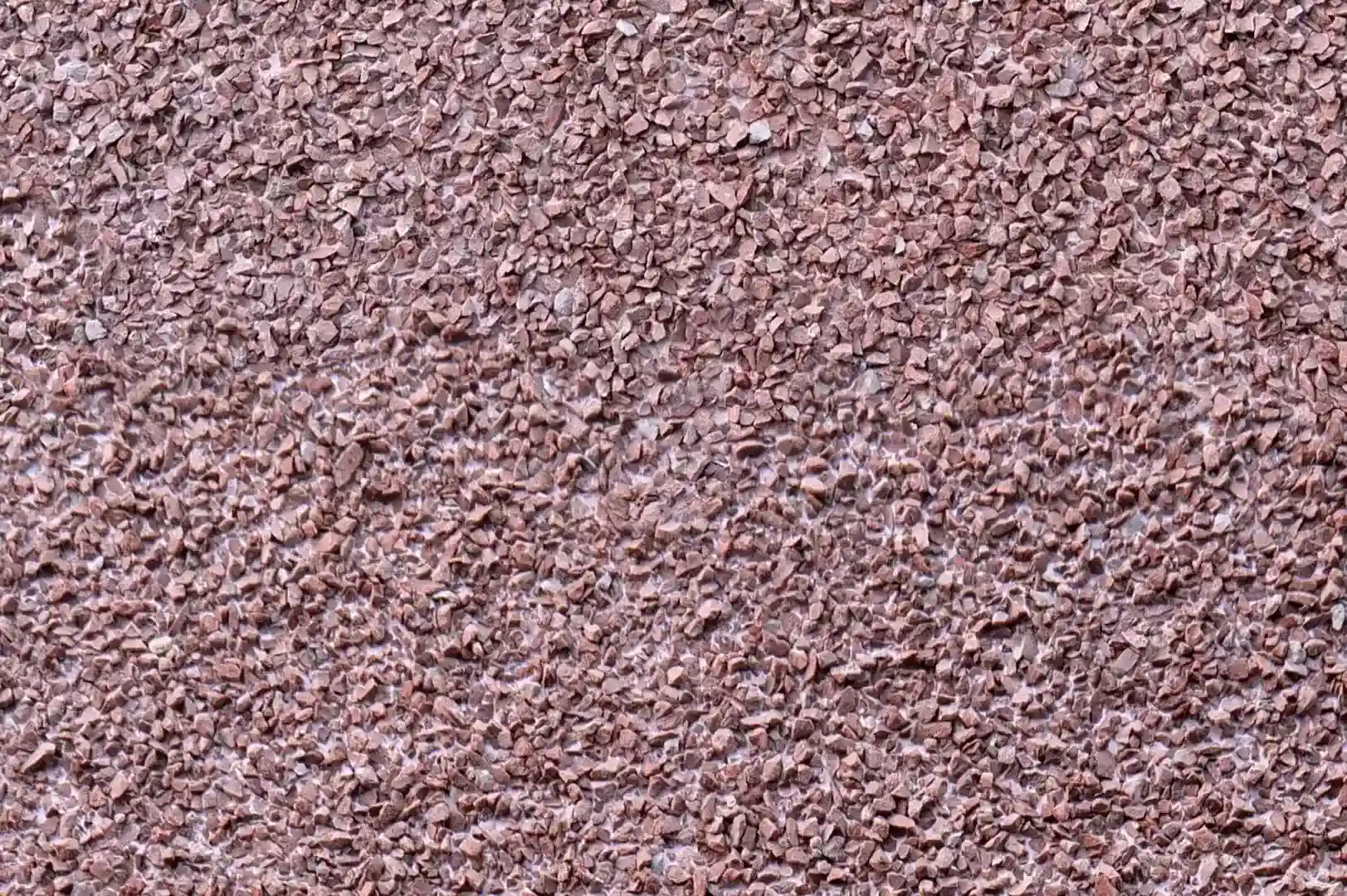 Close-up of red granite exposed aggregate plaster