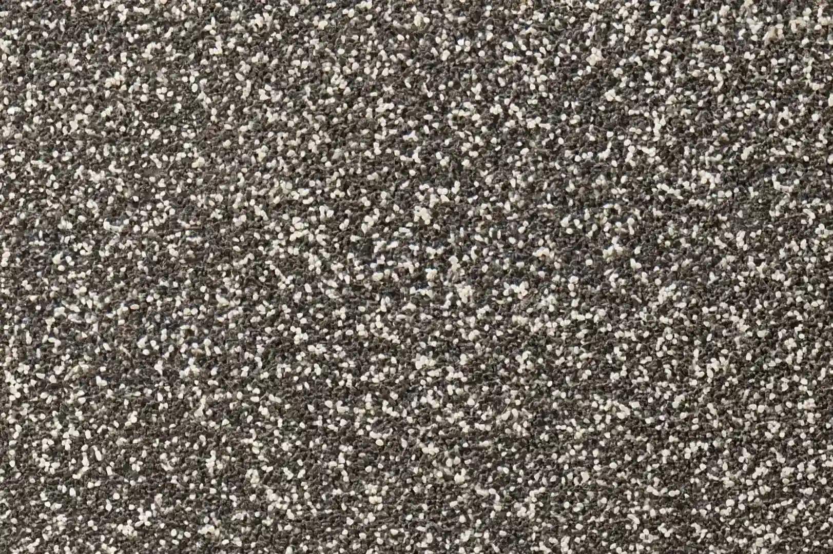 Close-up of a wall finishing with small black and white pebbles
