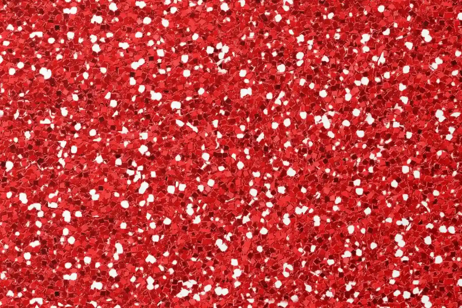 Close-up of a red sparkling background with white grains