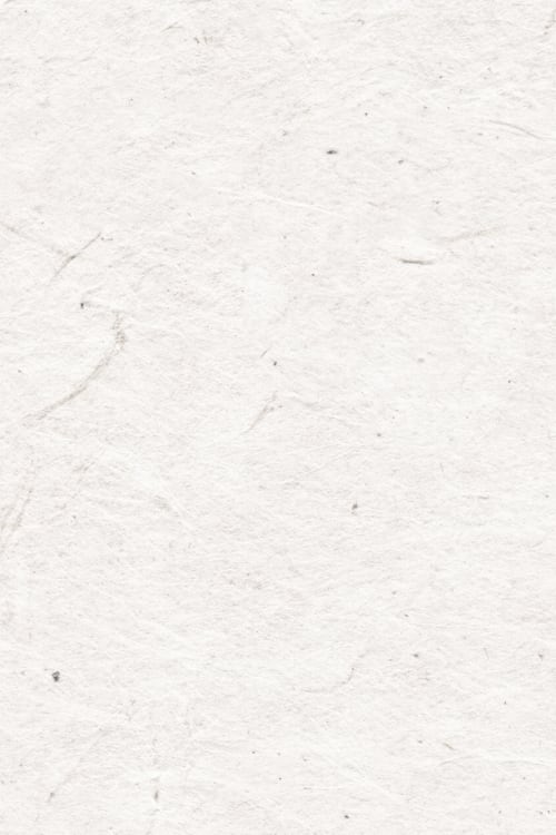 Close-up of a handmade paper with a few small dark colored specs