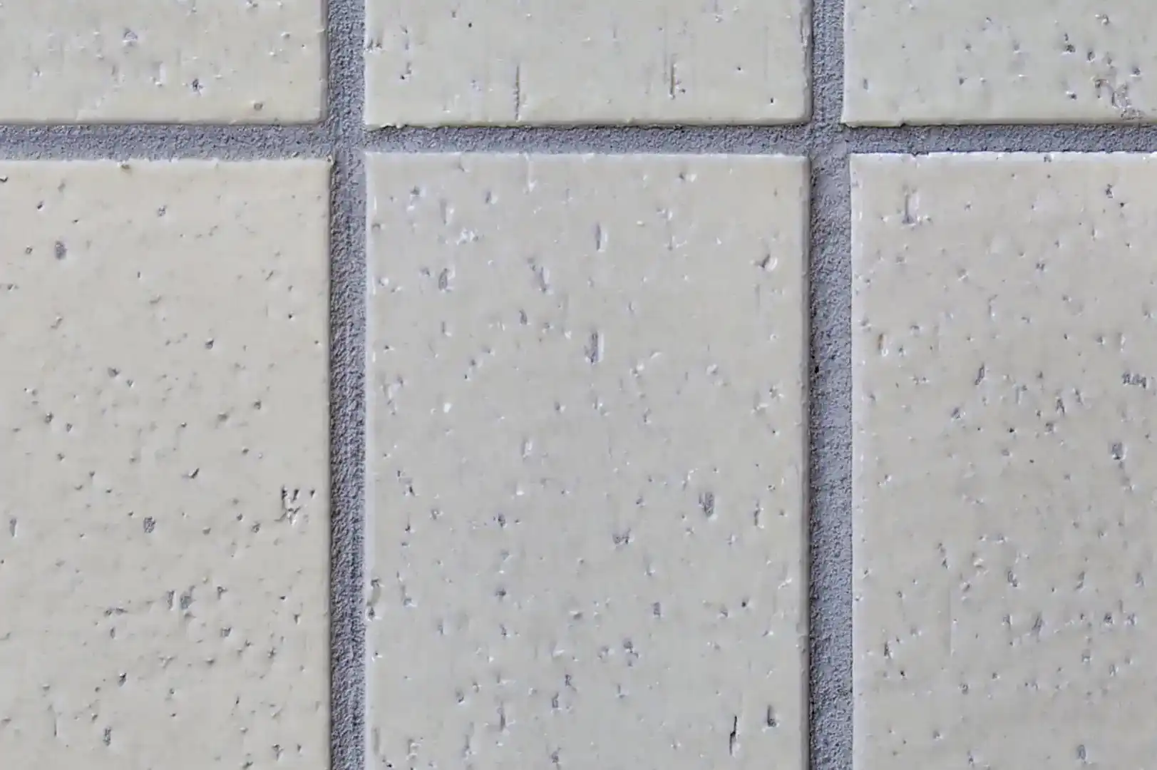 Close-up of an exterior tiled wall with glazed vertical tiles