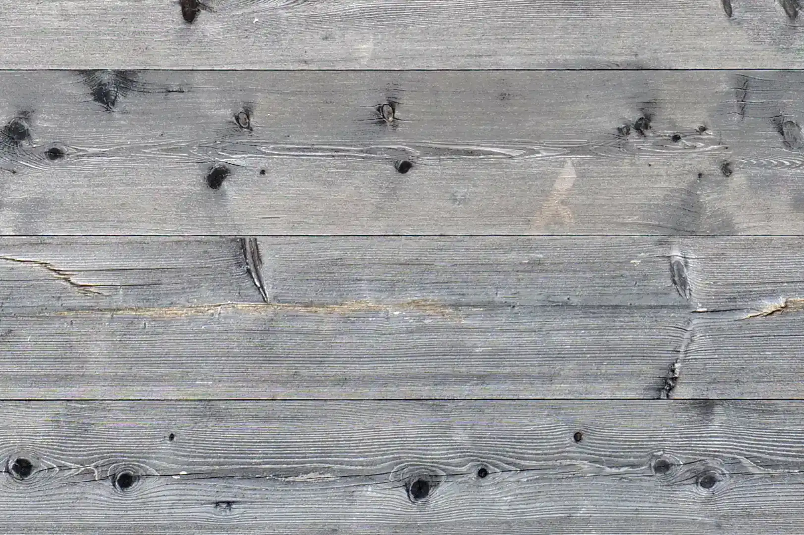 Close-up of a fence with slightly aged, natural horizontal wood planks