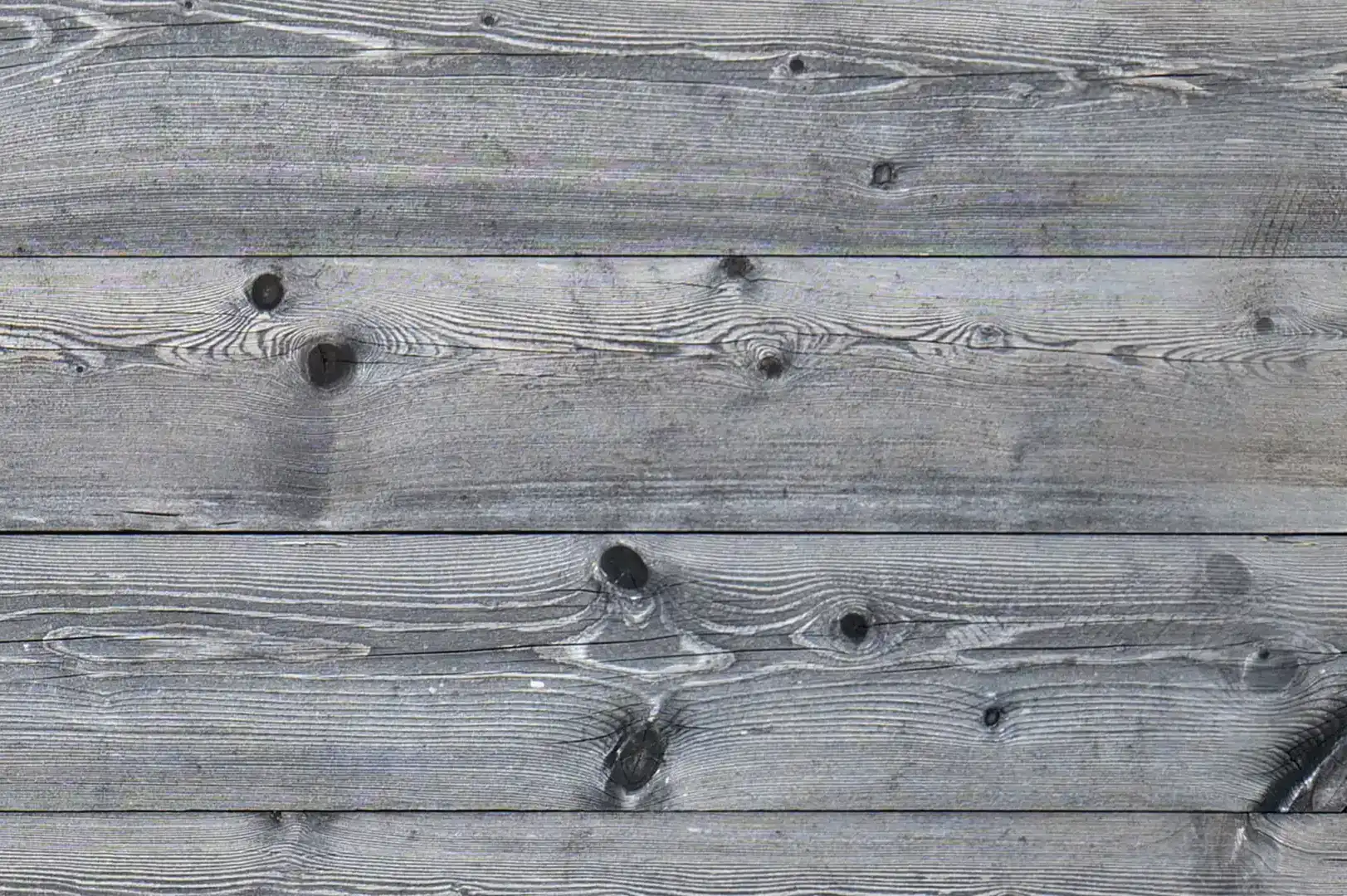 Close-up of a fence with slightly aged, natural horizontal wood planks
