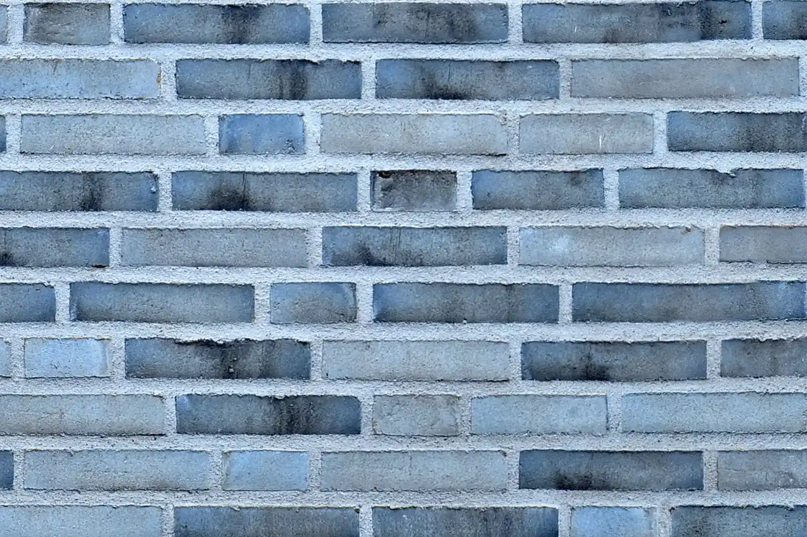 Close-up of a monochrome black & white decorative brick wall with a bluish tint