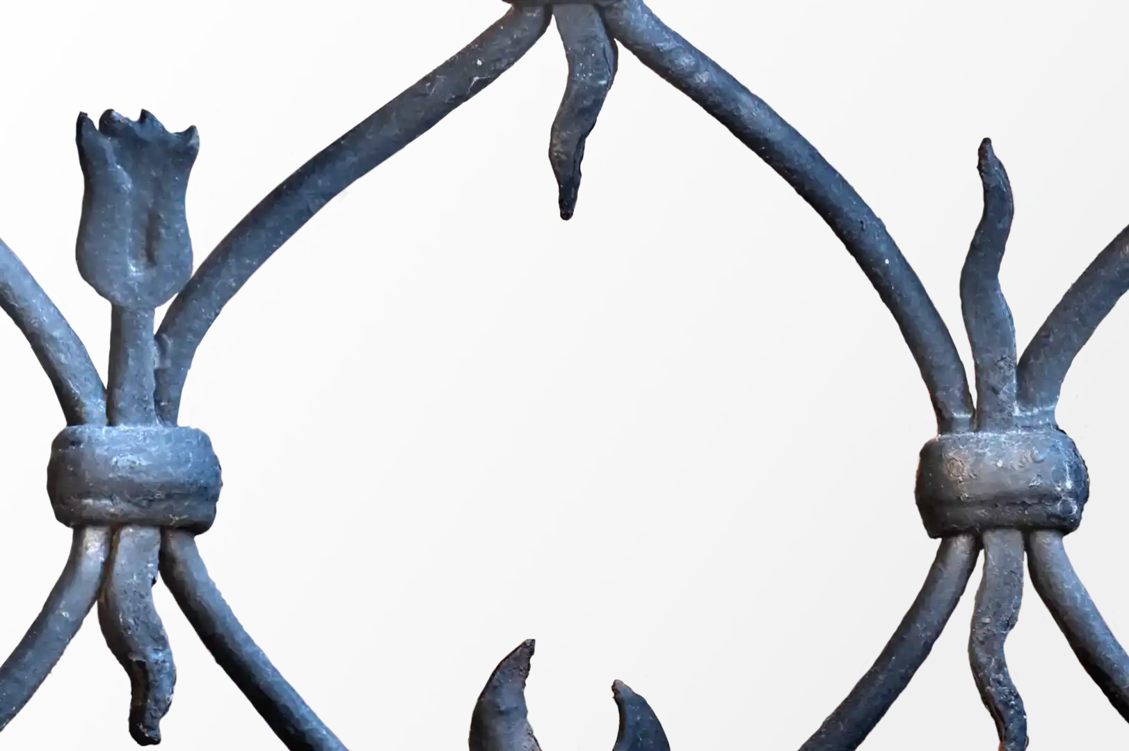 Close-up of an old wrought iron gate with decorative elements
