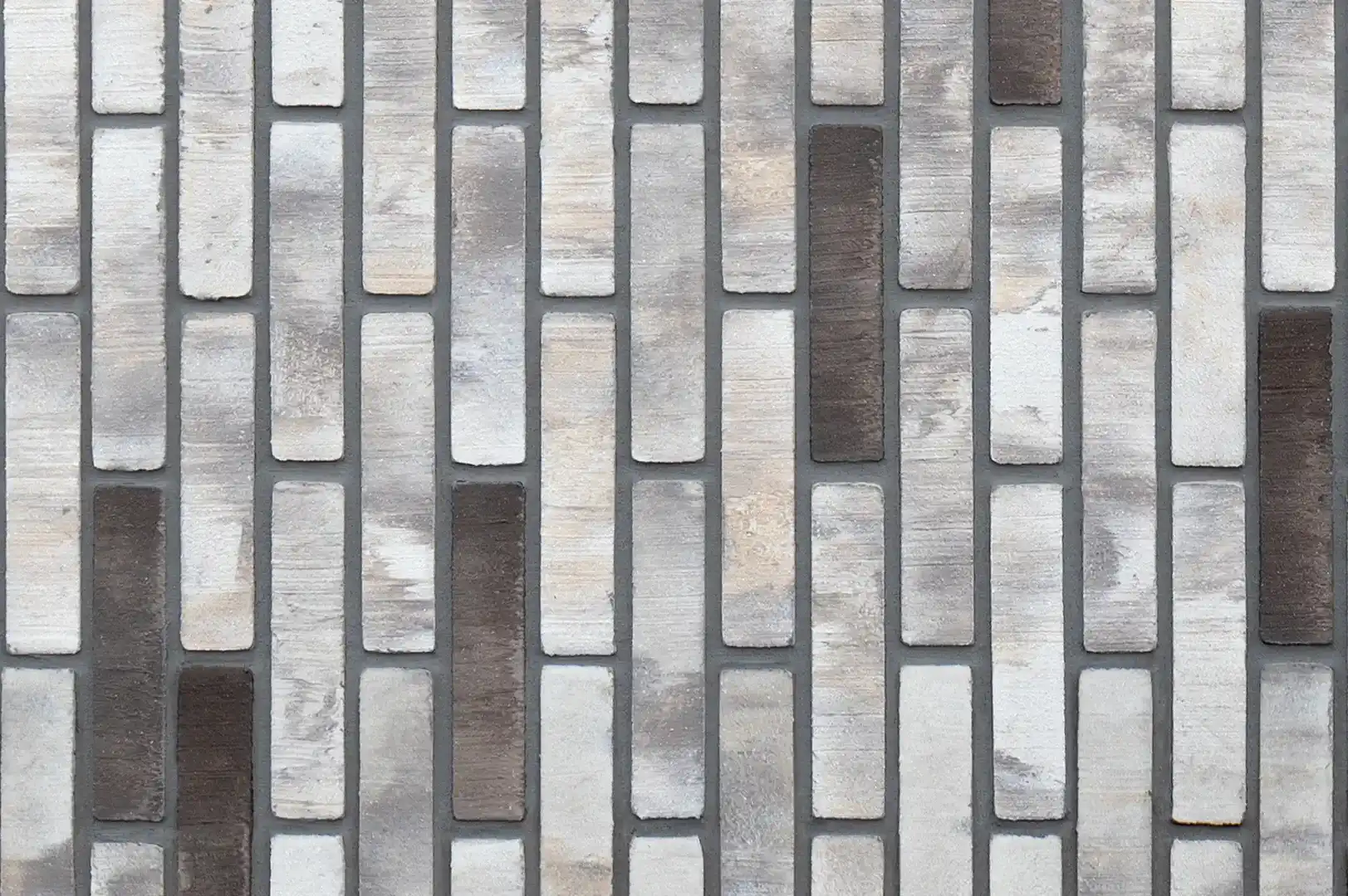 Close-up of a decorative vertical black, white & brown brick wall