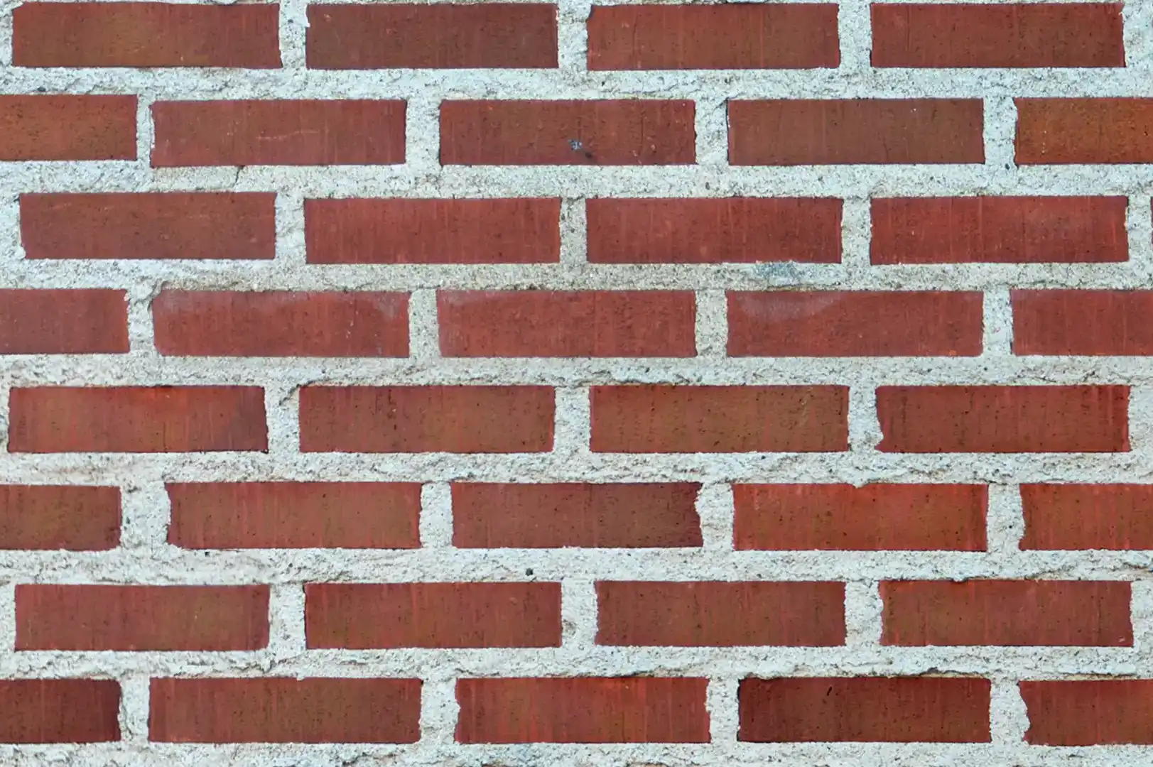Close-up of a clean dark red brick wall