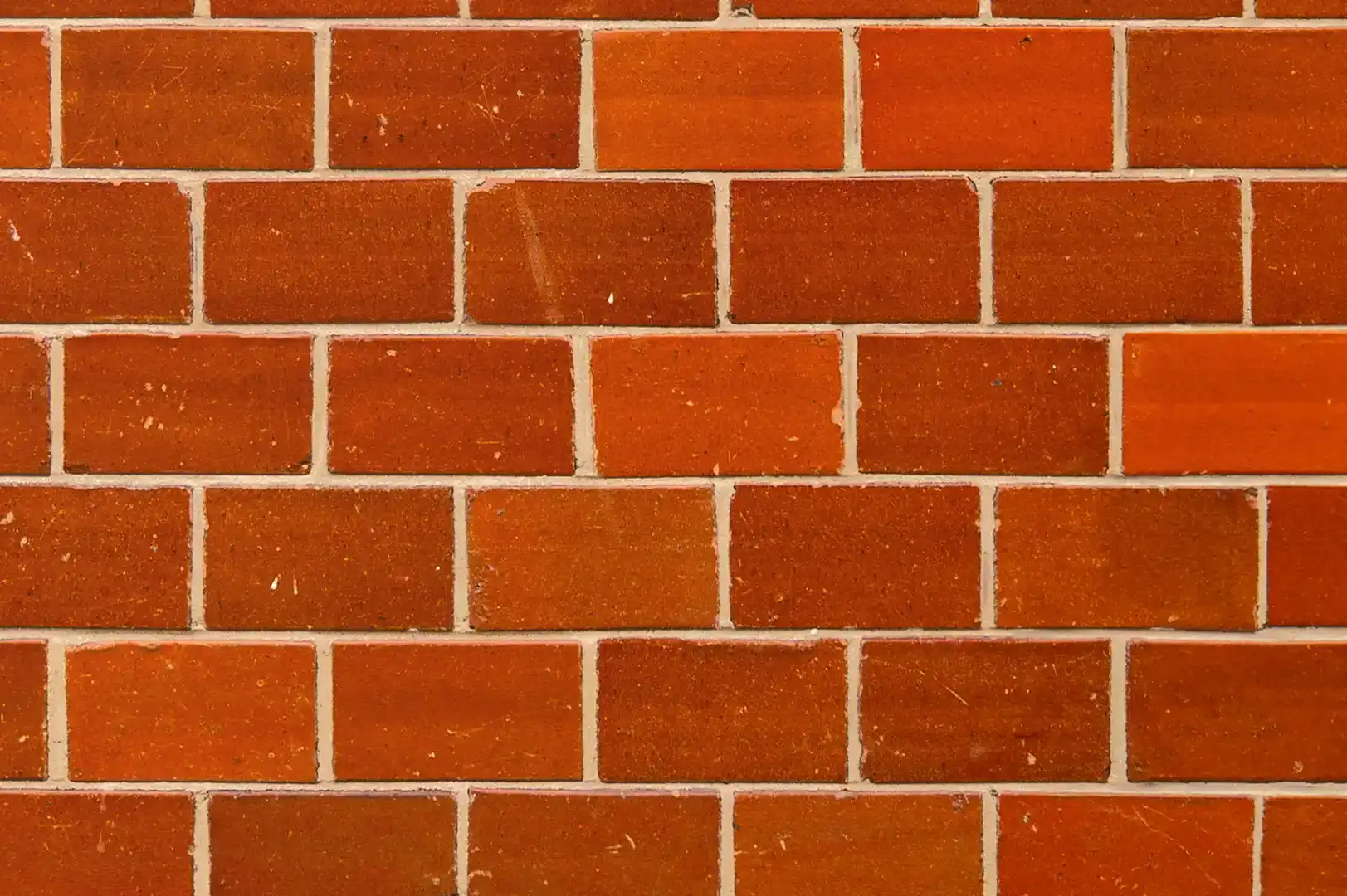 Close-up of a glazed decorative red brick wall