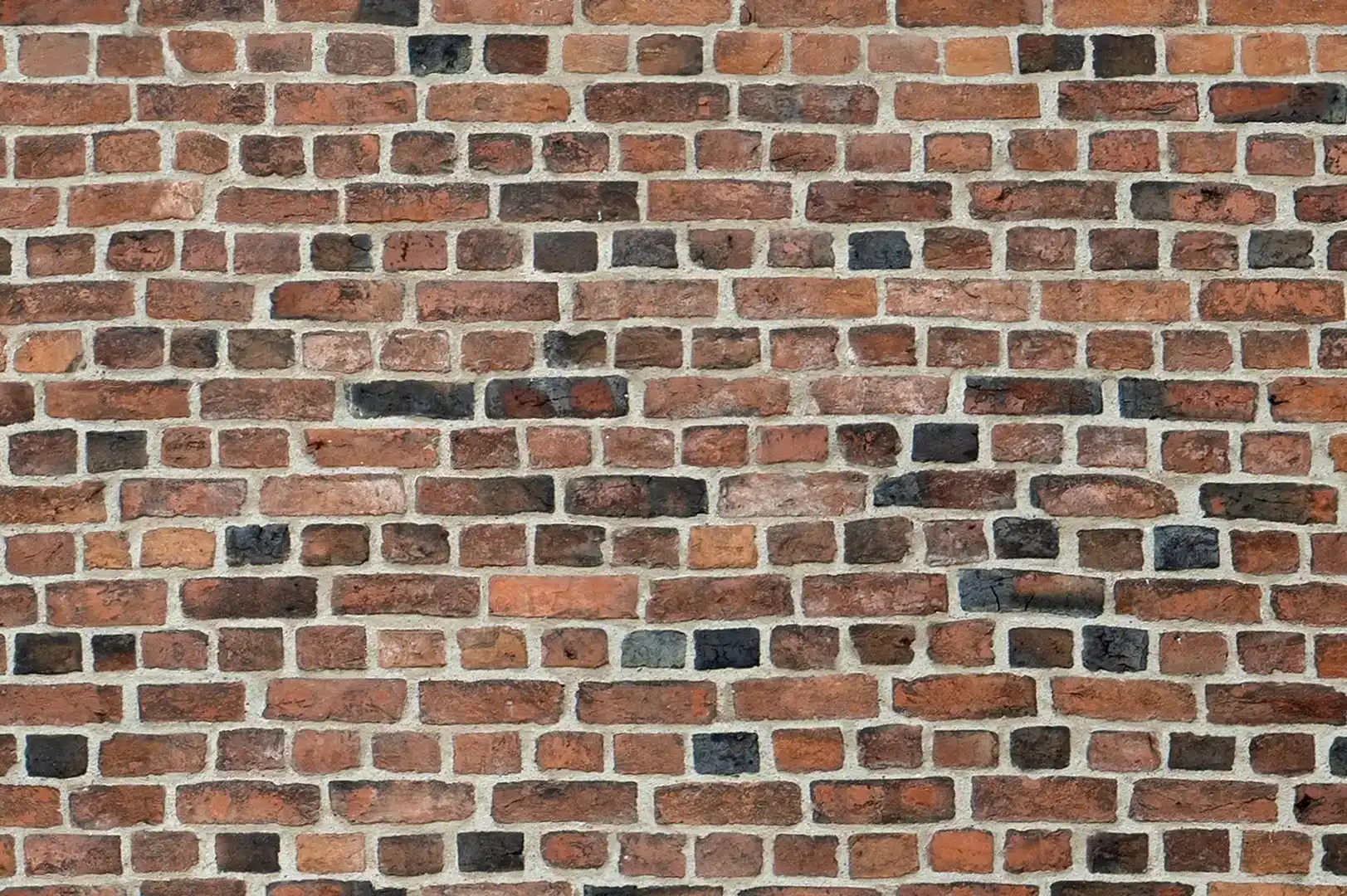 Close-up of a colorful church brick wall with a clean white mortar