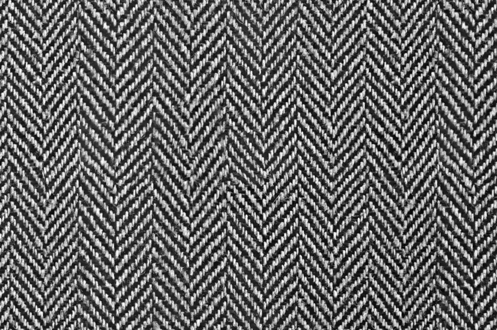 Close-up of a black and white woven fabric with a fishbone pattern
