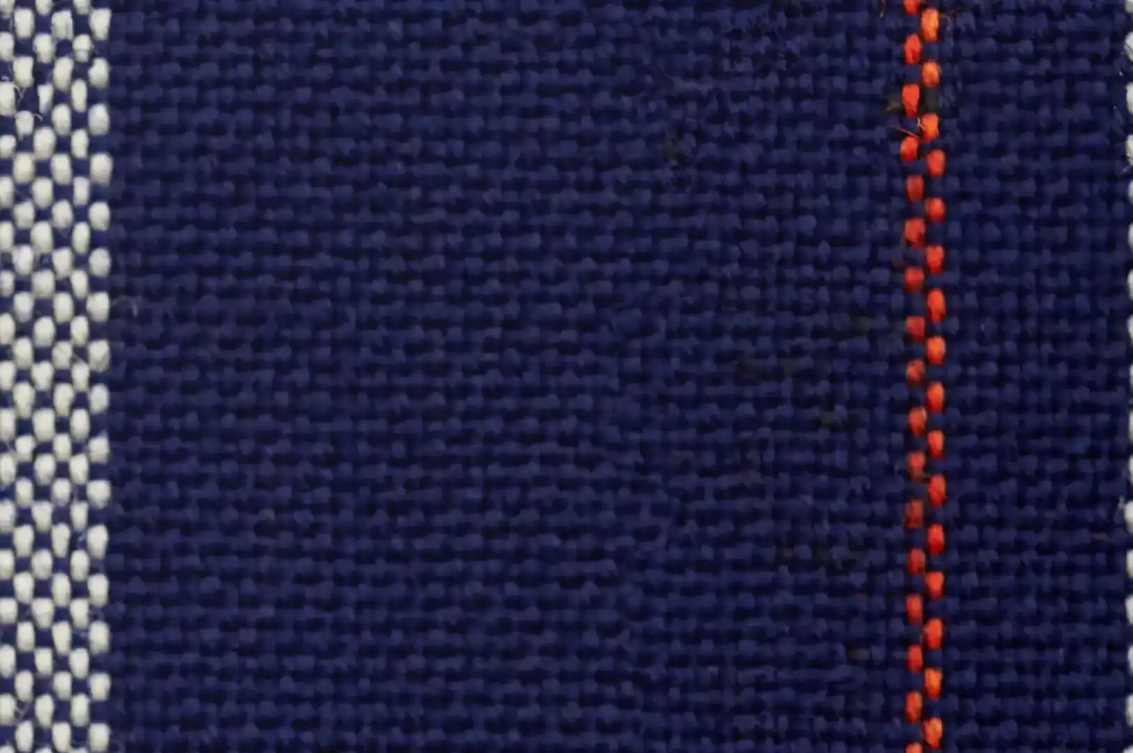 Close-up of a machine woven blue cloth with orange and white stripes