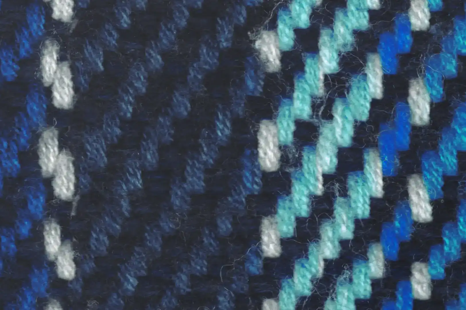 Close-up of a knitted scarf with blue shaded yarns
