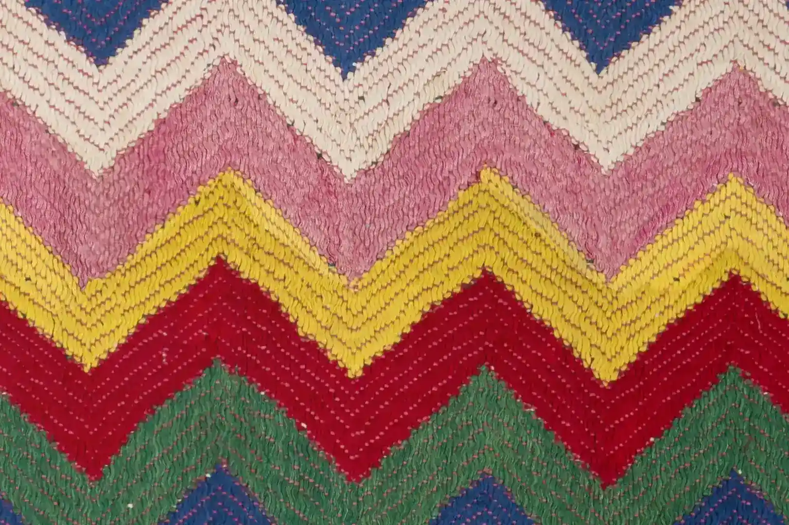 Close-up of a multicoloured handwoven rug in a zigzag pattern