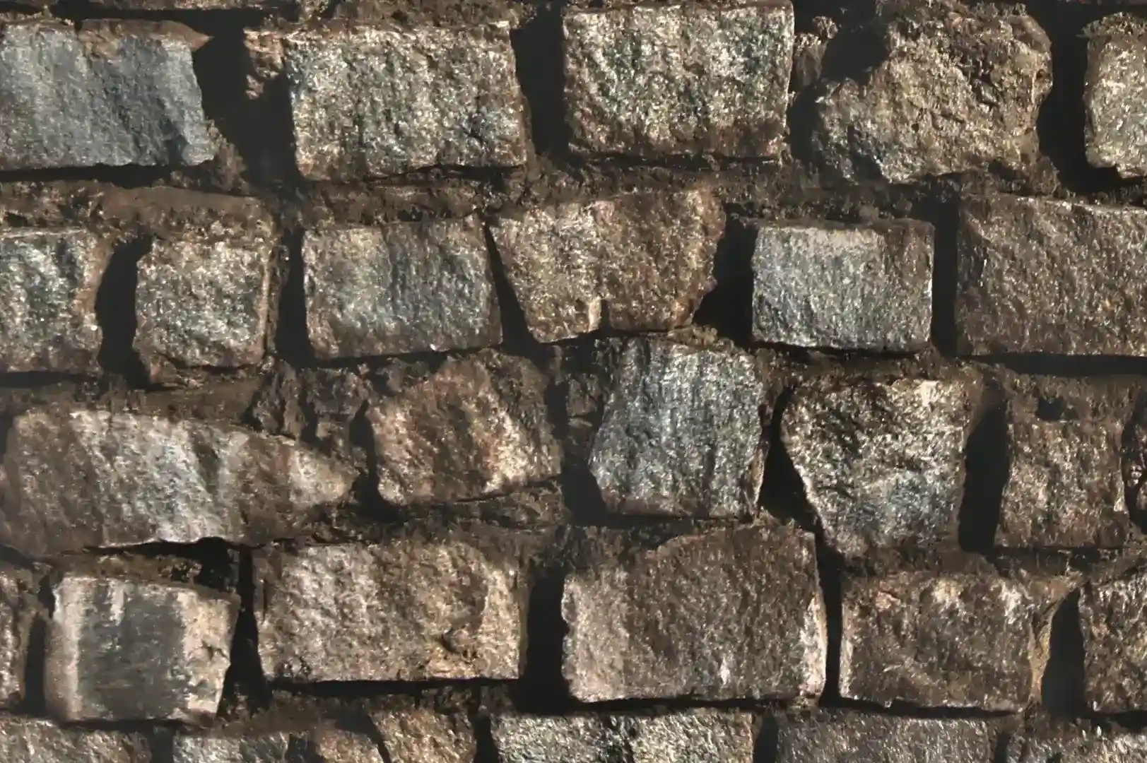 Close-up of a rectangular shaped stone wall with thick mortar