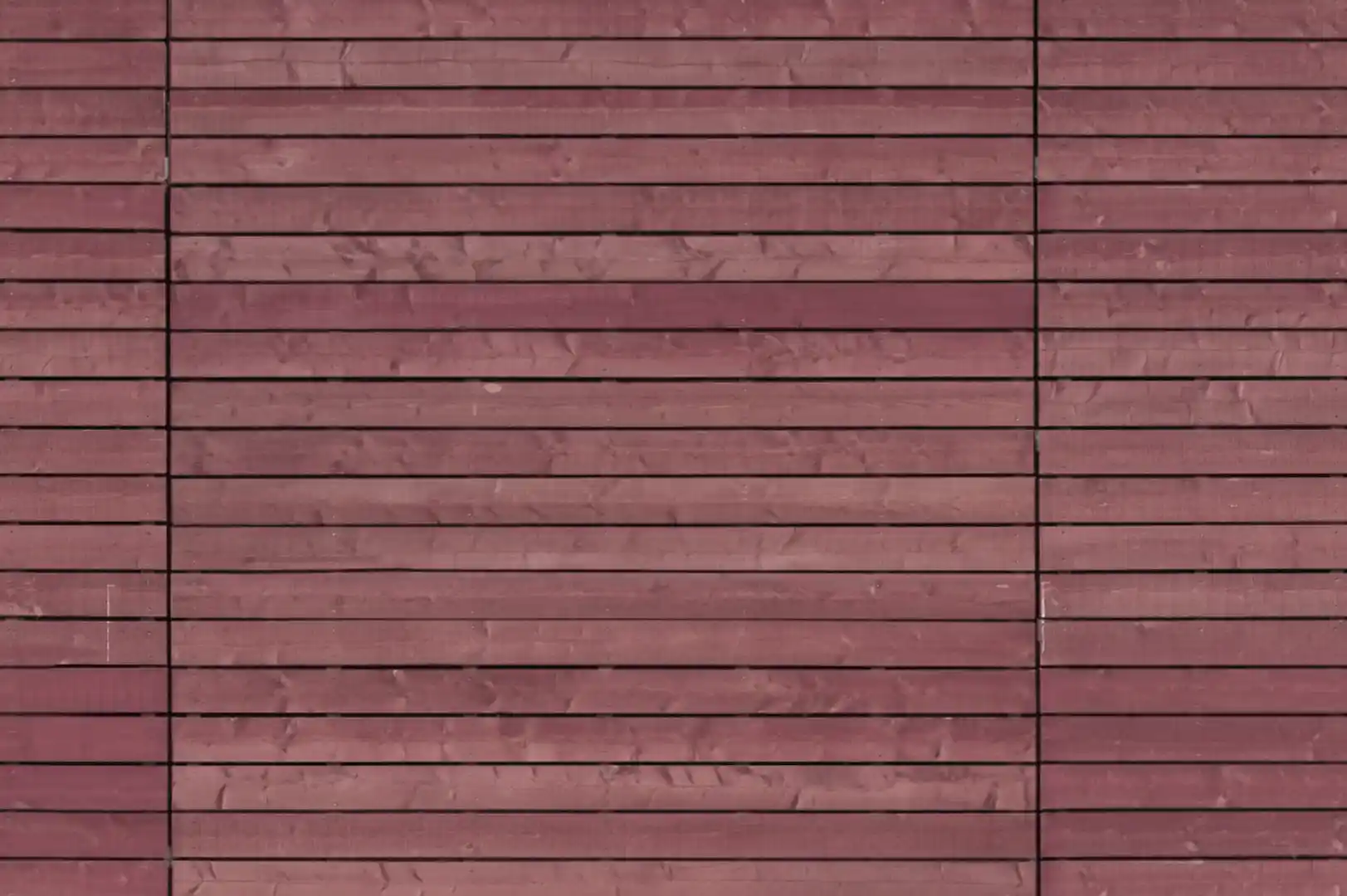 Close-up of a facade covered with horizontal wood planks with gaps between them