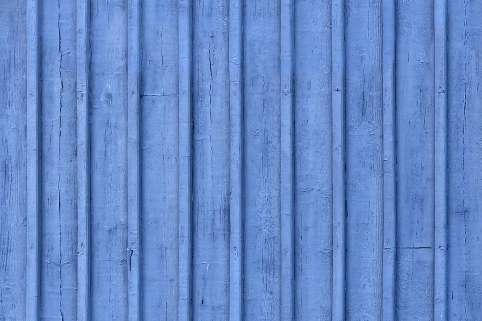 Close-up of a house exterior timber cladding with overlapping planks painted in blue